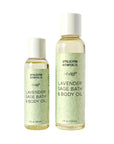 Two bottles of Appalachian Botanicals Lavender Sage Bath & Body Oil on a light gray background, one 2 fl oz and one 4 fl oz, with pale green labels and white caps.
