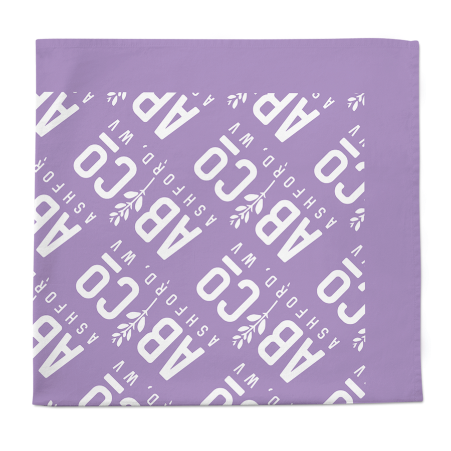 Purple bandana with the shortened Appalachian Botanical logo printed repeatedly folded into a square